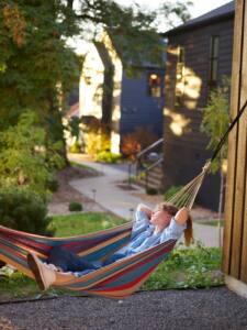 relaxed woman chilling in hammock in countryside